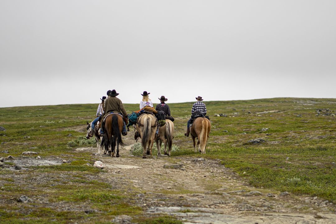 Riders heading down the trail across the plateau