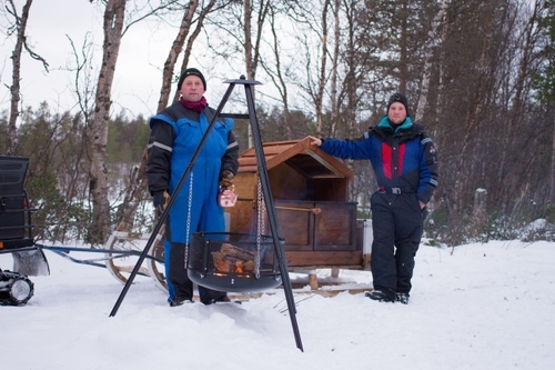 Guides with a sleigh and a fire pit at the farm
